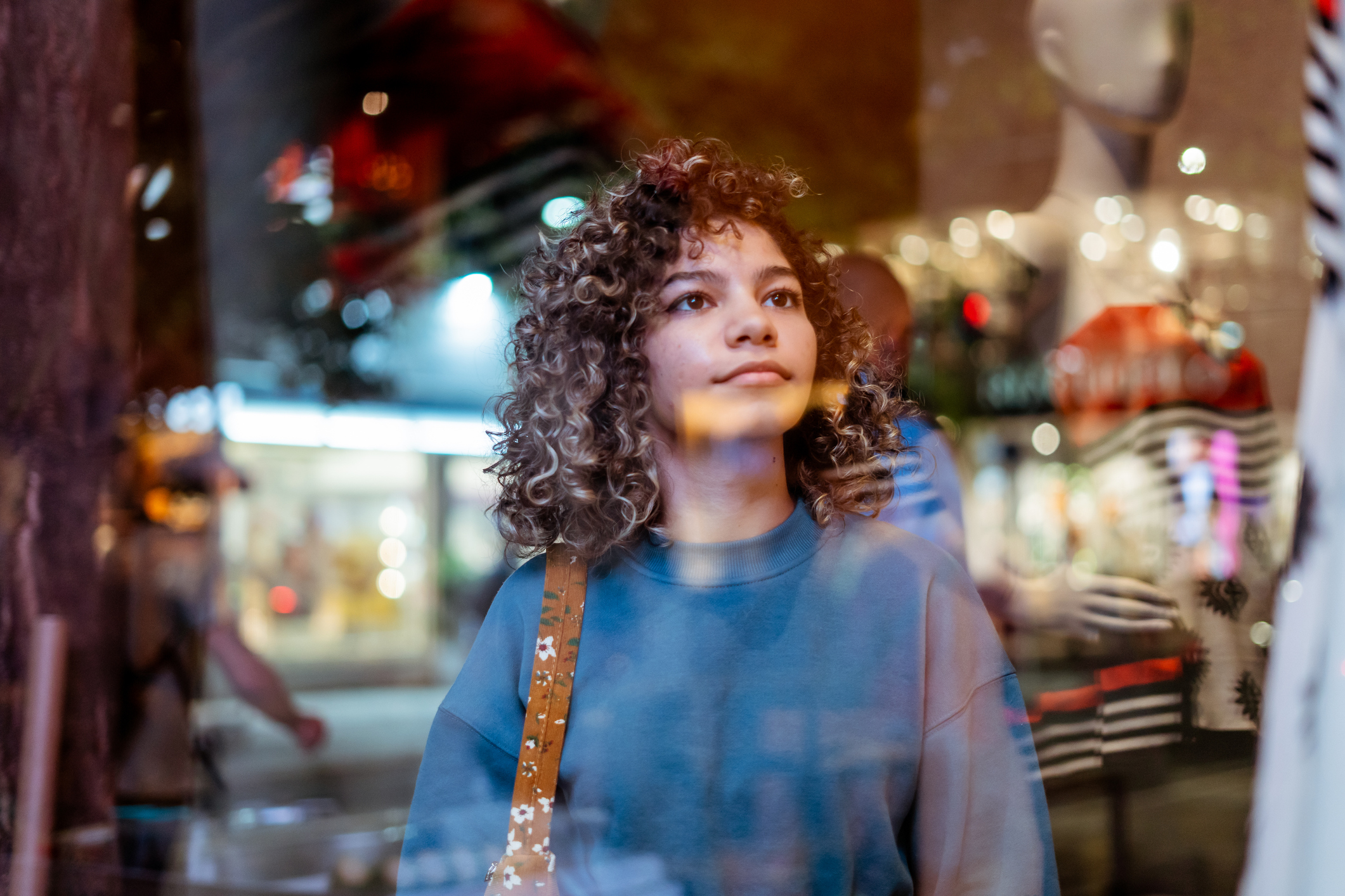 Young woman window shopping on the high street