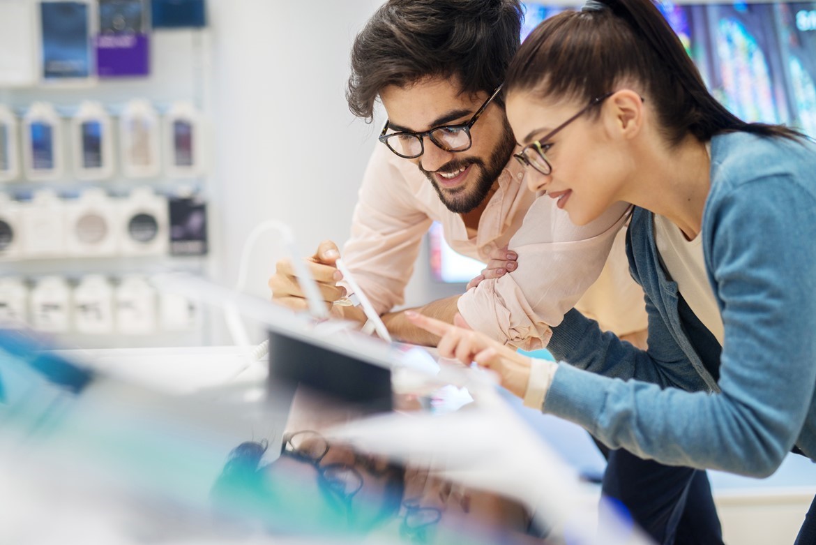 Man and woman in a technology store looking at electrical products