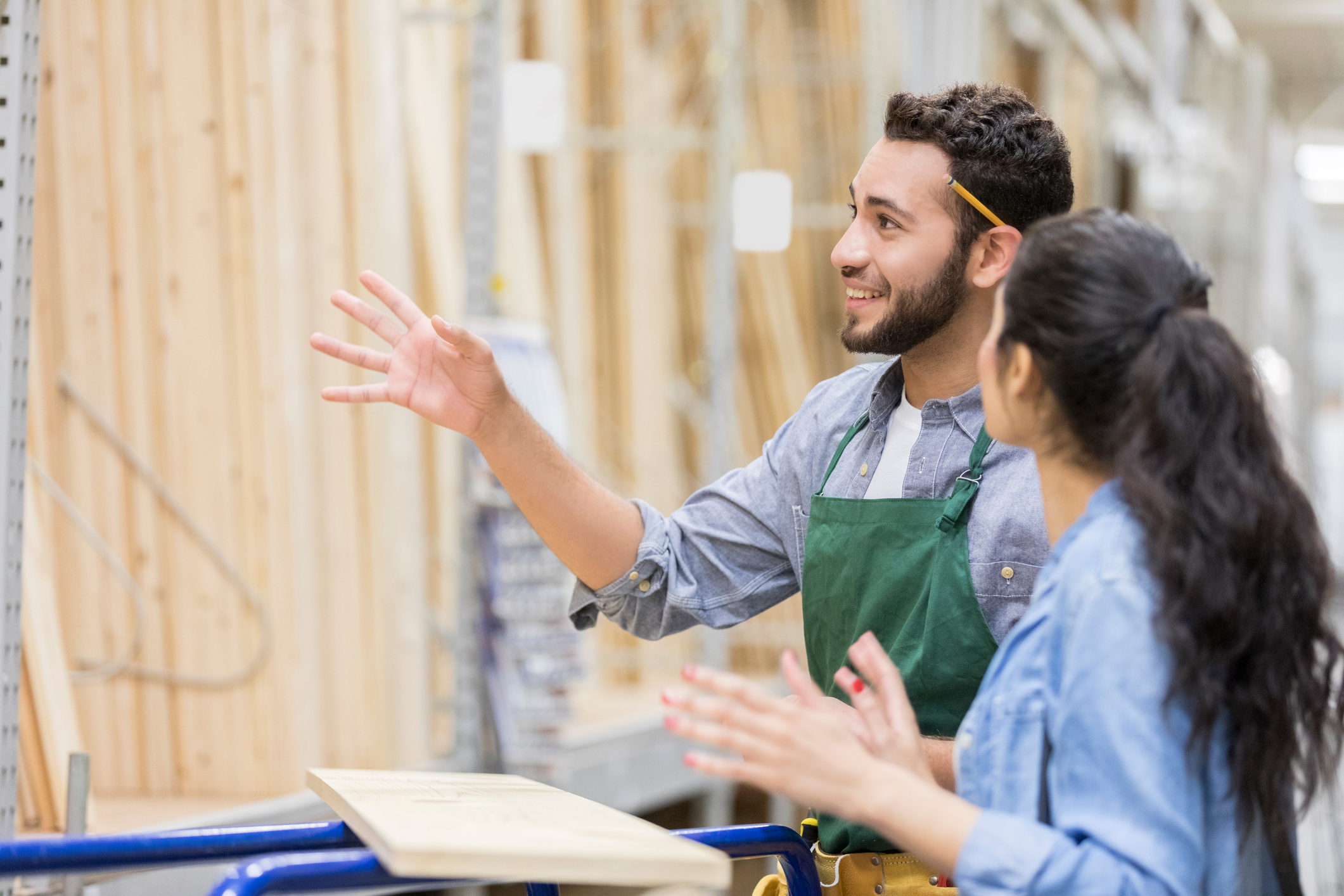 Male employee at a home improvement shop speaking to a customer