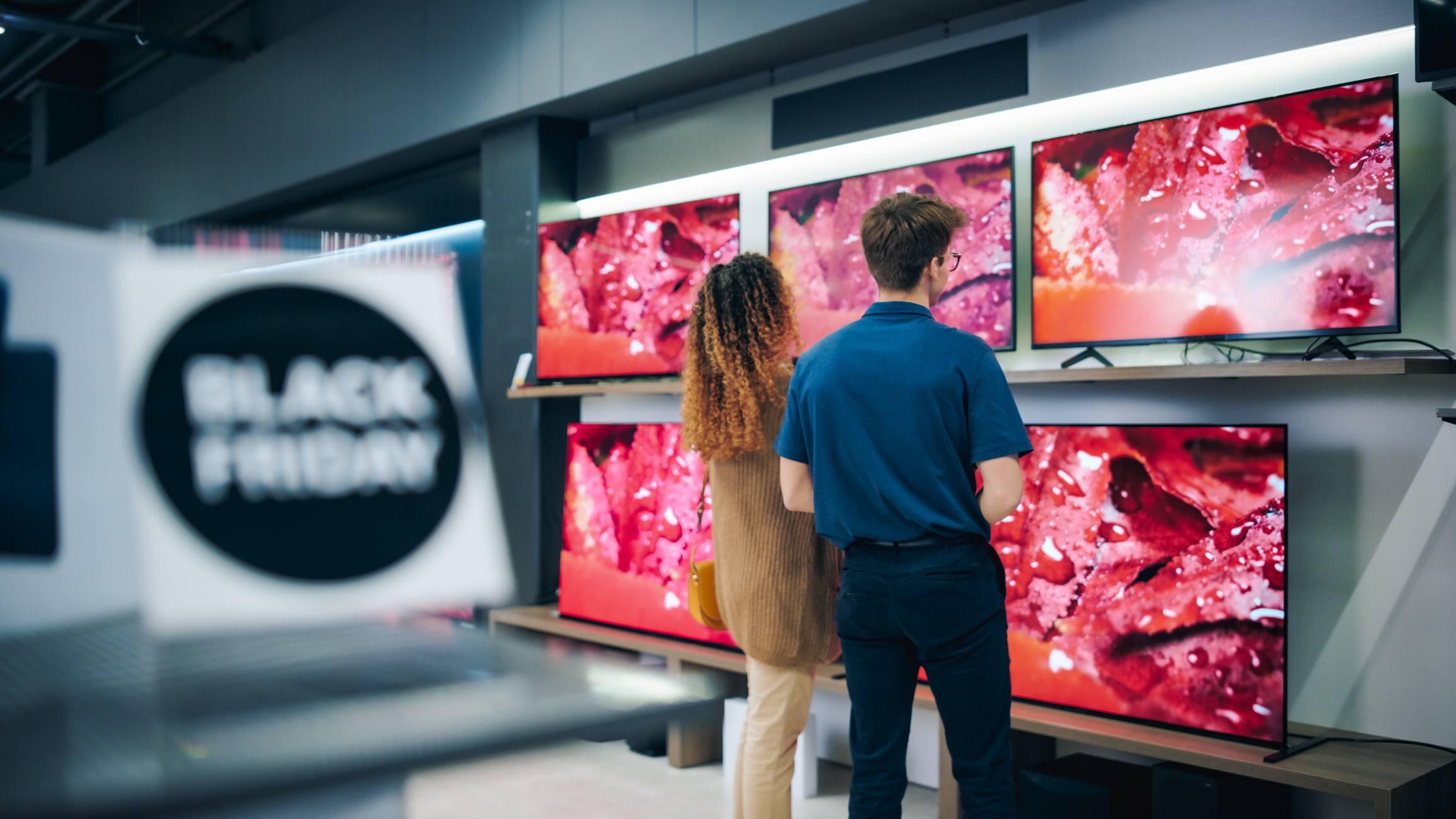 Man and woman shopping for a TV in the Black Friday sales