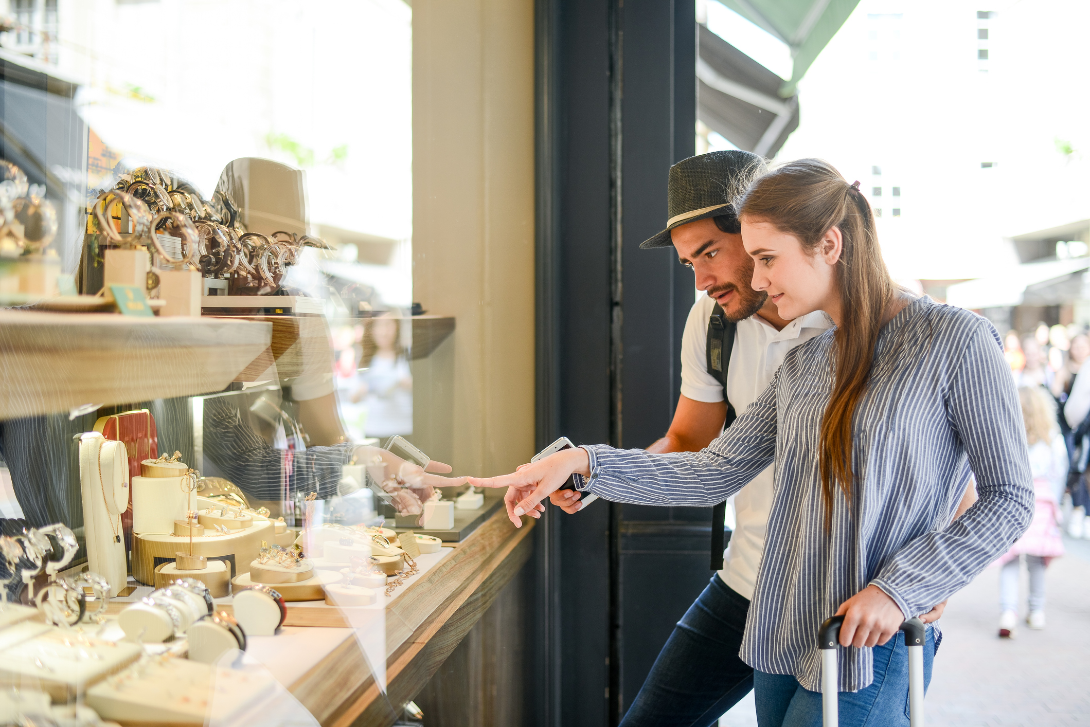 Couple looking in the window of a jewellery retailer on the high street