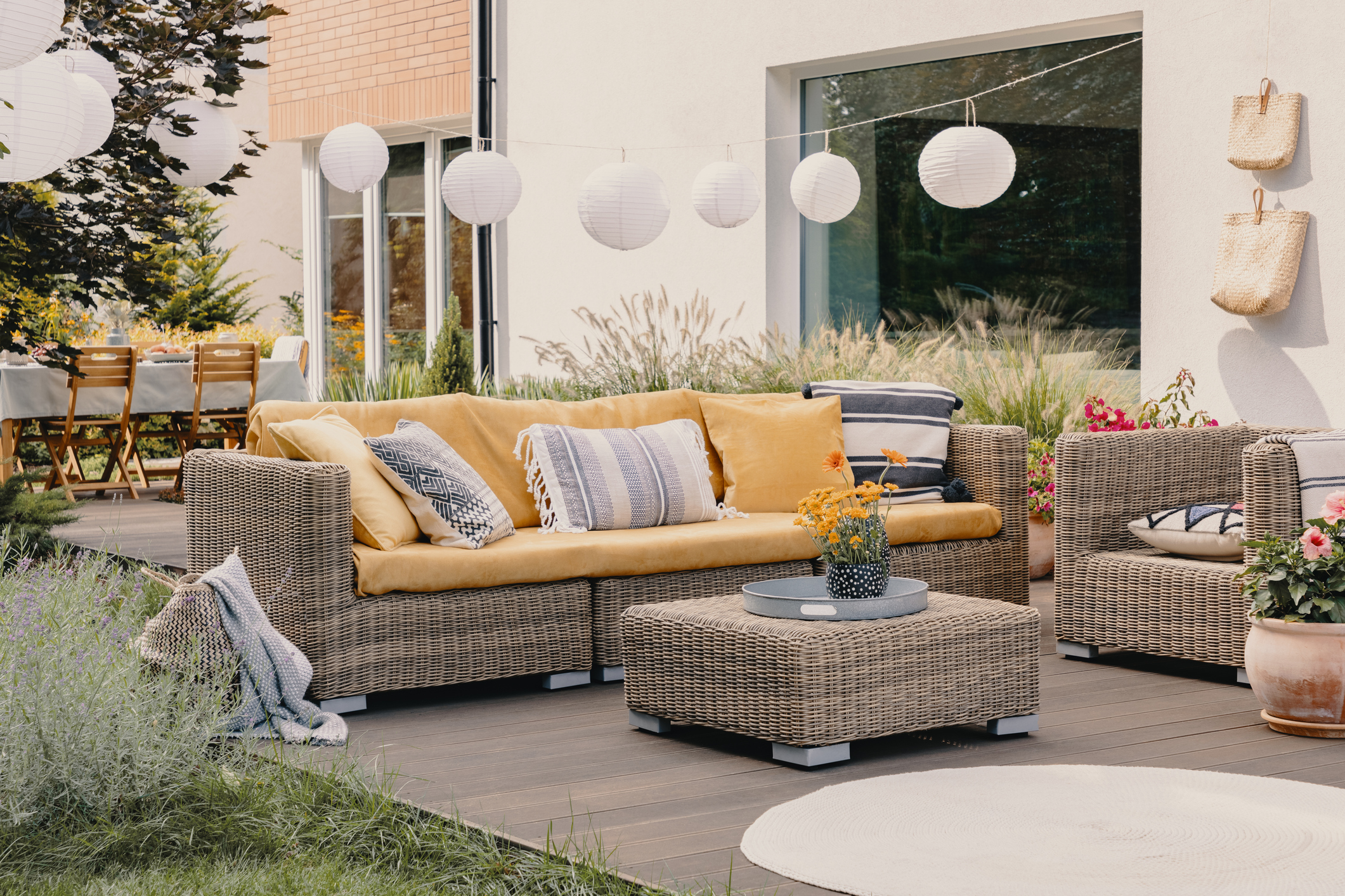 Garden furniture with yellow cushions on the three-seater garden sofa